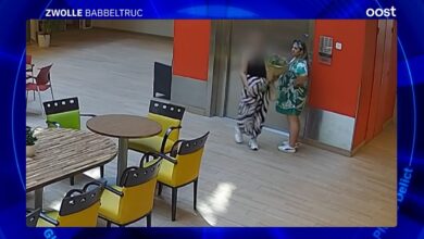 Twee vrouwen bij de lift in seniorencomplex Fermate in Zwolle, één met een bos bloemen. Het duo wordt verdacht van een babbeltruc waarbij sieraden van een 98-jarige vrouw zijn gestolen. Videostill RTV Oost