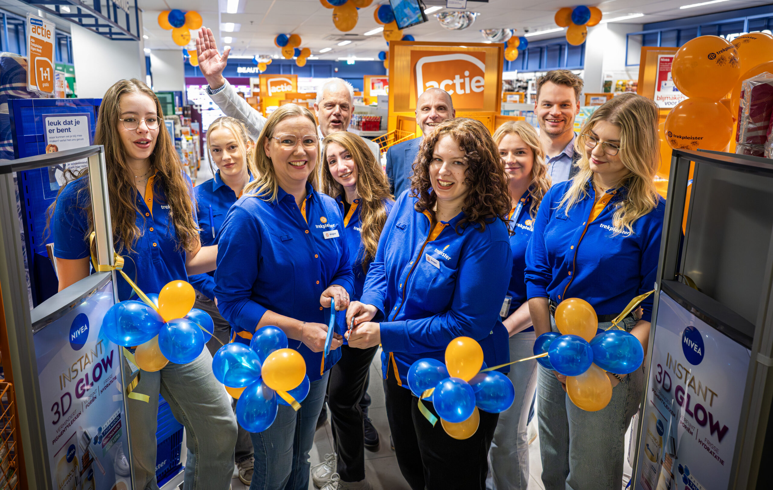 Team van Trekpleister Zwolle Diezerpoort knipt samen het lint door tijdens feestelijke opening.